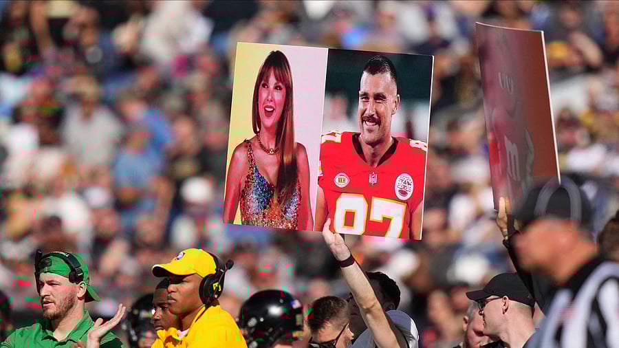 <div class="paragraphs"><p>Army Black Knights members hold up a call in play sign of American recording artist Taylor Swift and American football player Travis Kelce in the first half against the Air Force Falcons at Empower Field at Mile High.</p></div>