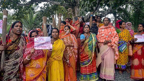 <div class="paragraphs"><p>Women holding posters stage a protest demanding the arrest of local TMC leaders over Sandeshkhali incident allegations, in North 24 Parganas district, Sunday, Feb. 25, 2024.</p></div>