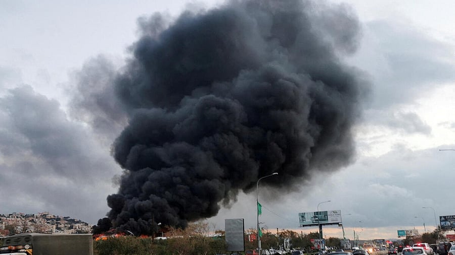 <div class="paragraphs"><p>Vehicles drive as smoke rises from a site hit by an airstrike after what Lebanon's state media said was a series of Israeli strikes, near the town of Ghaziyeh on Lebanon's coast around 60 km north of the border with Israel, Lebanon</p></div>