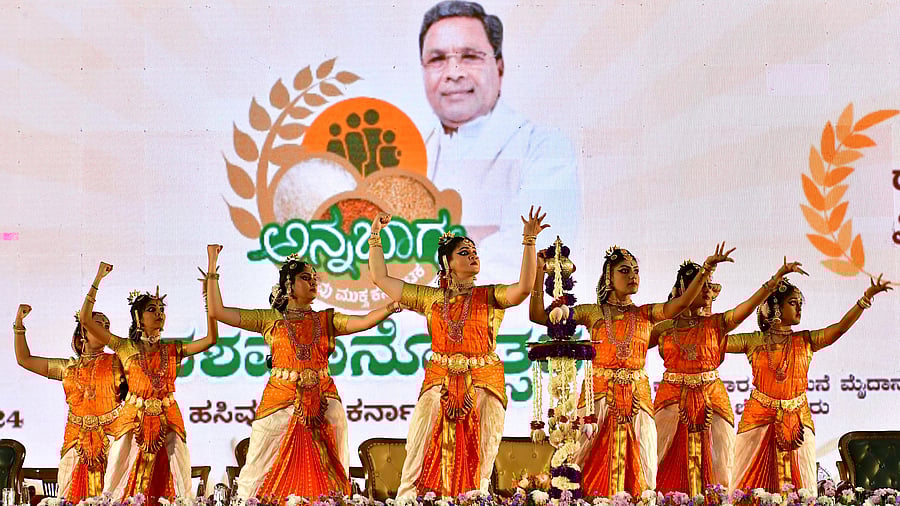 <div class="paragraphs"><p>Artistes perform at the decennial celebrations of ‘Anna Bhagya’ scheme, in Bengaluru on Thursday. </p></div>