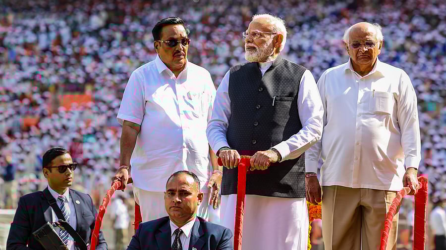 <div class="paragraphs"><p>Prime Minister Narendra Modi with Gujarat CM Bhupendra Patel and the state BJP chief CR Paatil greets the gathering during the golden jubilee celebration of Gujarat Cooperative Milk Marketing Federation in Ahmedabad.</p></div>
