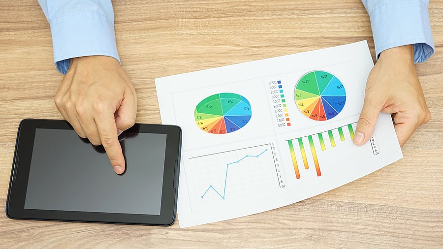 <div class="paragraphs"><p>Businessman analyzing financial report and using tablet computer at the same time.</p></div>