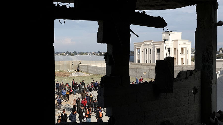 <div class="paragraphs"><p>Palestinians gather near a house hit by an Israeli strike, in Rafah in the southern Gaza Strip February 16, 2024. </p></div>