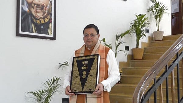 <div class="paragraphs"><p> Chief Minister Pushkar Singh Dhami leaves from his residence with a copy of the Constitution, in Dehradun, Tuesday, Feb. 6, 2024.</p></div>