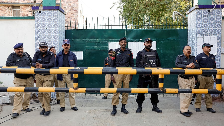 <div class="paragraphs"><p>Police officers stand guard at the entrance of the provincial election commission of Pakistan, as supporters of former Prime Minister Imran Khan's party, the Pakistan Tehreek-e-Insaf, gather demanding free and fair results of the election, a day after general elections in Karachi, Pakistan February 9, 2024. </p></div>