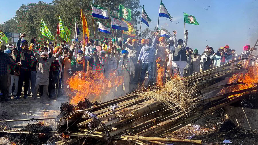 <div class="paragraphs"><p>Farmers holding flags shout slogans against corporate houses during a protest as part of their 'Delhi Chalo' march, near the Punjab-Haryana Shambhu border, in Patiala.</p></div>