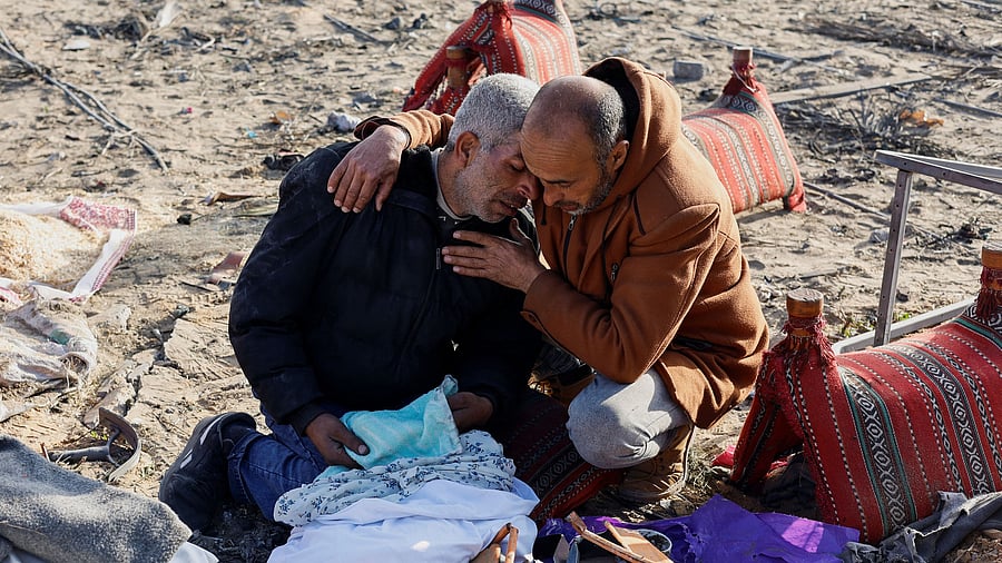 <div class="paragraphs"><p>Palestinians react as they gather at the site of an Israeli strike on a house, amid the ongoing conflict between Israel and Palestinian Islamist group Hamas, in Rafah, in the southern Gaza Strip, February 18, 2024. </p></div>