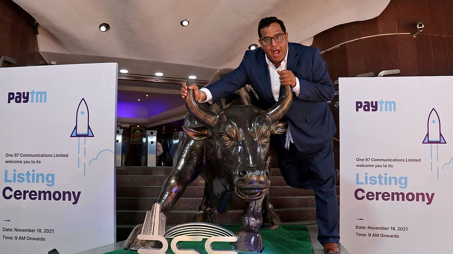 <div class="paragraphs"><p>FILE PHOTO: Paytm founder and CEO Vijay Shekhar Sharma poses with a bronze replica of a bull after the company's IPO listing ceremony at the Bombay Stock Exchange in Mumbai, India, November 18, 2021. </p></div>