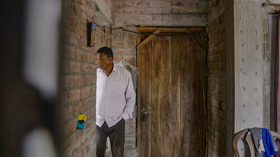 <div class="paragraphs"><p>North 24 Parganas: Local TMC leader Ajit Maity takes shelter inside a house after he was allegedly chased by villagers at Sandeshkhali, in North 24 Parganas district, Sunday, Feb. 25, 2024.</p></div>