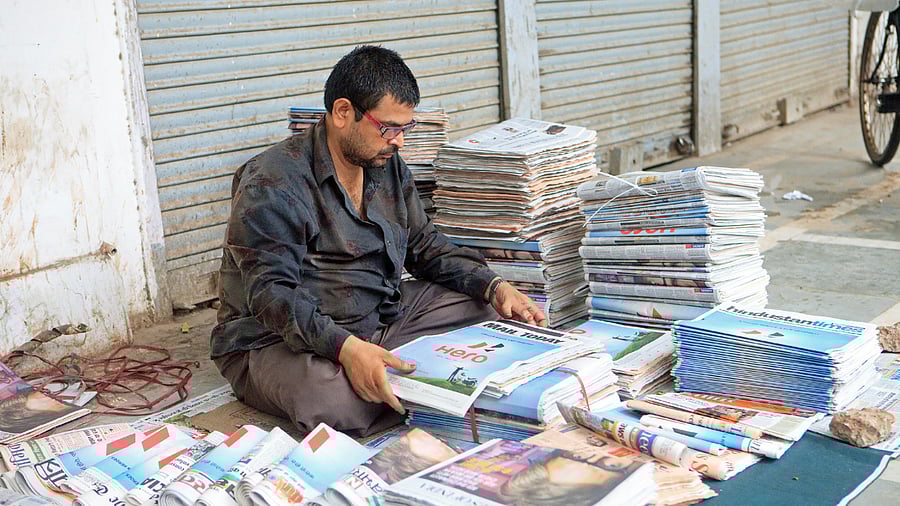 <div class="paragraphs"><p>A newspaper vendor seen at a roadside in Delhi. </p></div>
