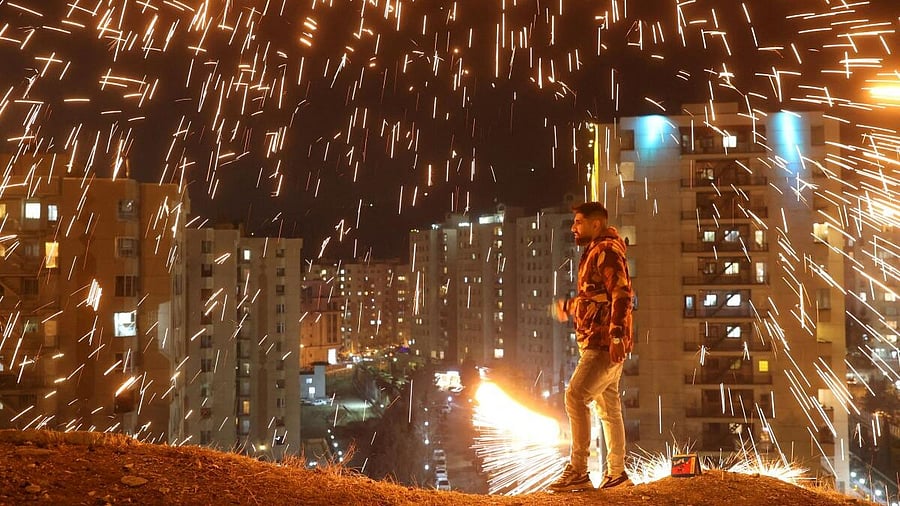 <div class="paragraphs"><p>An Iranian man lights a firework during the Wednesday Fire celebration (Chaharshanbeh Suri in Persian) at a park in Tehran, Iran March 12, 2024.</p></div>