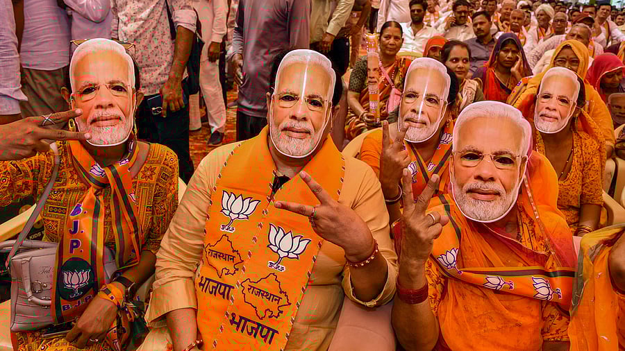 <div class="paragraphs"><p>BJP supporters wear masks of Prime Minister Narendra Modi</p></div>