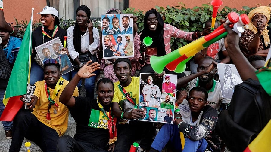 <div class="paragraphs"><p>Supporters cheer as Senegalese opposition leader Ousmane Sonko holds a joint press conference with the presidential candidate he is backing in the March 24 election.</p></div>