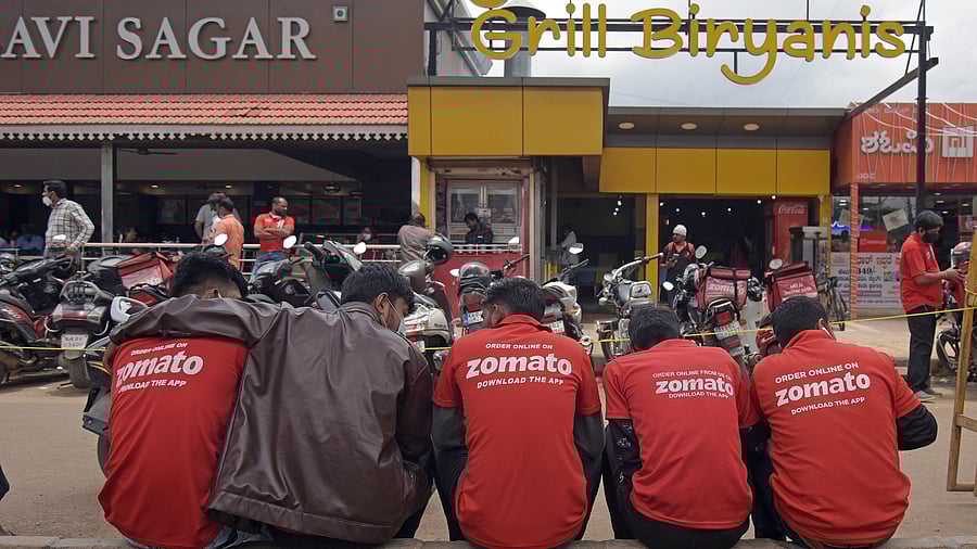 <div class="paragraphs"><p>Delivery executives wait outside a restaurant to pick-up orders.</p></div>