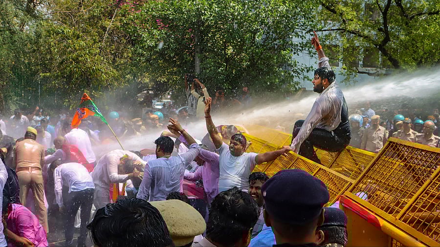 <div class="paragraphs"><p>Security personnel use water cannon to disperse BJP workers during their protest demanding the resignation of Delhi Chief Minister Arvind Kejriwal over his arrest by the ED in connection with an excise policy-linked money-laundering case, in New Delhi, Tuesday, March 26, 2024. </p></div>
