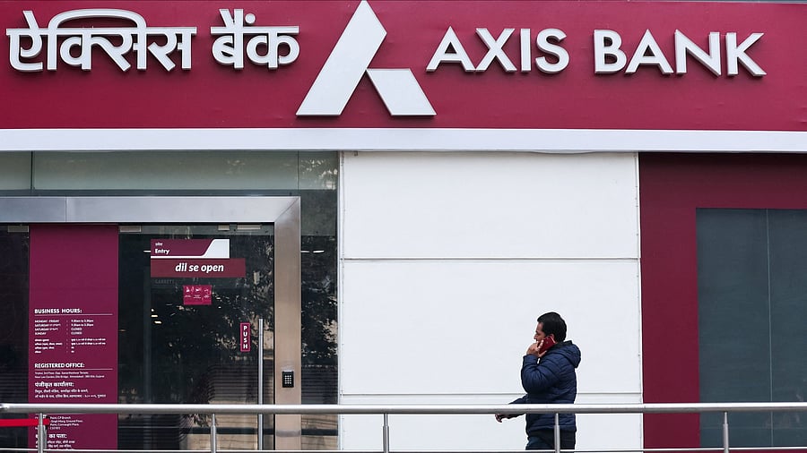 <div class="paragraphs"><p>A man walks outside a branch of Axis Bank.</p></div>