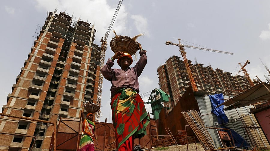 <div class="paragraphs"><p>Labourers work at the construction site of a residential complex in Noida on the outskirts of New Delhi.</p></div>
