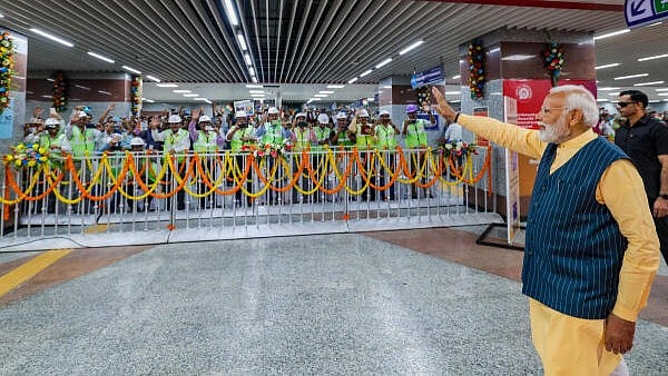 <div class="paragraphs"><p>Prime Minister Narendra Modi waves at metro workers during foundation stone laying and inauguration of multiple connectivity projects, in Kolkata, Wednesday, March 6, 2024.</p></div>