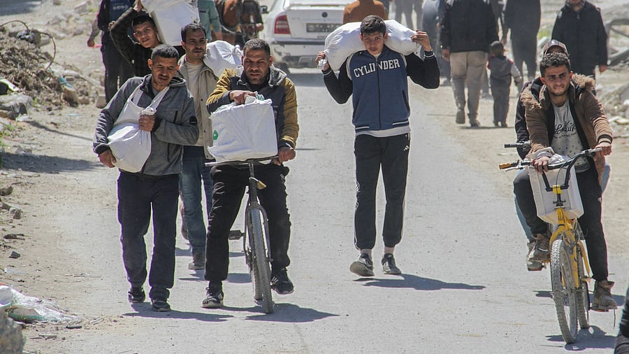 <div class="paragraphs"><p>Palestinians carry aid unloaded from a truck, amid the ongoing conflict between Israel and Hamas, in Gaza City.</p></div>