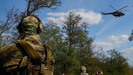 <div class="paragraphs"><p>A Russian army helicopter flies above, as volunteers of a newly formed battalion take part in a training in the Russian miltary training.</p></div>