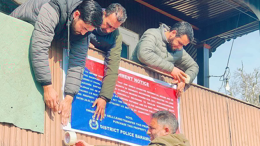 <div class="paragraphs"><p>Police personnel put up a notice of attachment at a property owned by a person allegedly involved in drug peddling. (Representative image)</p></div>