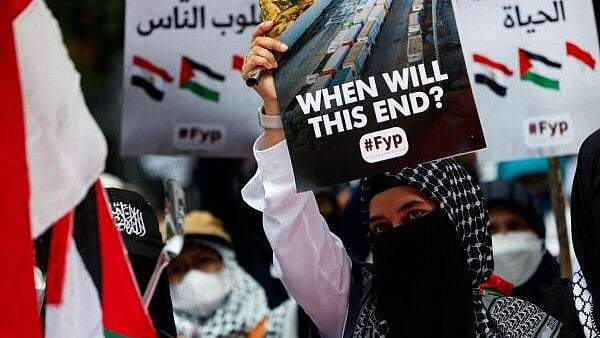 <div class="paragraphs"><p>A demonstrator supporting Palestinians in Gaza holds a placard during a protest urging the Egyptian government to open the Rafah border crossing to get aid delivered to Gaza, outside the Egyptian embassy in Jakarta, Indonesia, March 4, 2024.</p></div>