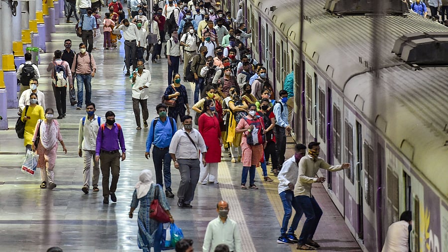 <div class="paragraphs"><p>Commuters rush to board a local train in Mumbai.</p></div>