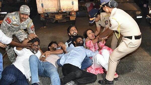 <div class="paragraphs"><p>Police detain an AAP volunteer during aprotest against the arrest of Delhi Chief Minister Arvind Kejriwal in Mumbai.</p></div>
