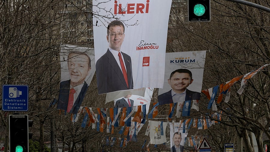 Election banners of Istanbul's mayor Ekrem Imamoglu, President Tayyip Erdogan and Murat Kurum, mayoral candidate of Erdogan's ruling AK Party hang along a street ahead of the local elections in Istanbul, Turkey, March 28, 2024. REUTERS/Umit Bektas