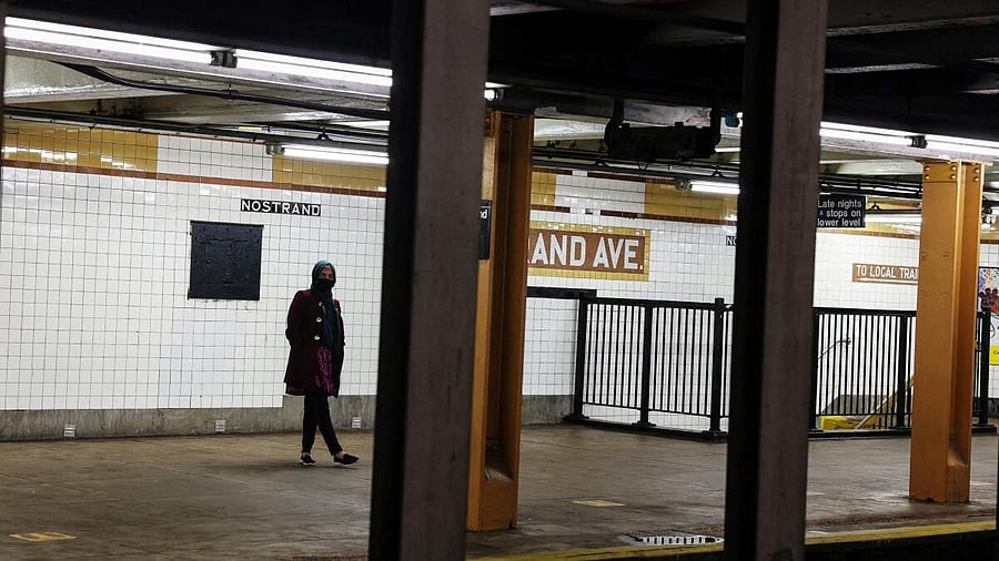 <div class="paragraphs"><p>A woman waits for a subway to arrive at the Nostrand Avenue station subway platform in the Brooklyn borough of New York City.</p></div>