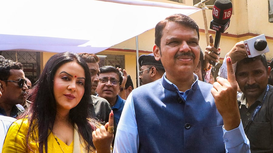 <div class="paragraphs"><p>Maharashtra Deputy Chief Minister Devendra Fadnavis shows his finger marked with indelible ink after casting his vote for the first phase of Lok Sabha elections, in Nagpur, Friday, April 19, 2024. </p></div>