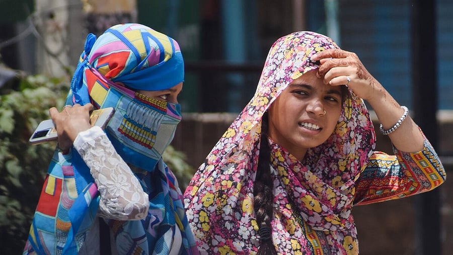<div class="paragraphs"><p>A photo of commuters using scarves to shield themselves from the heat on a hot summer day.</p></div>