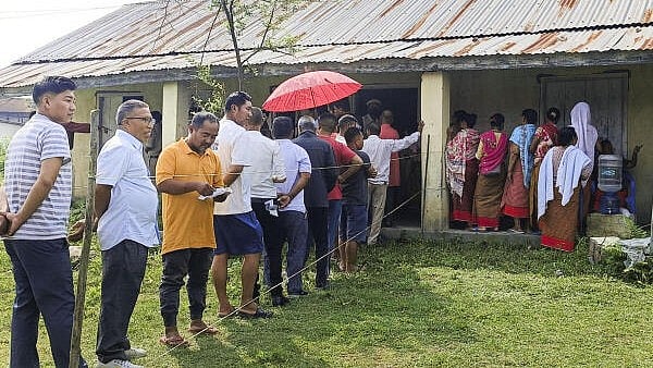 <div class="paragraphs"><p>Voters wait in a queue at a polling station to cast their votes for the first phase of Lok Sabha elections, in Manipur, Friday, April 19, 2024.</p></div>