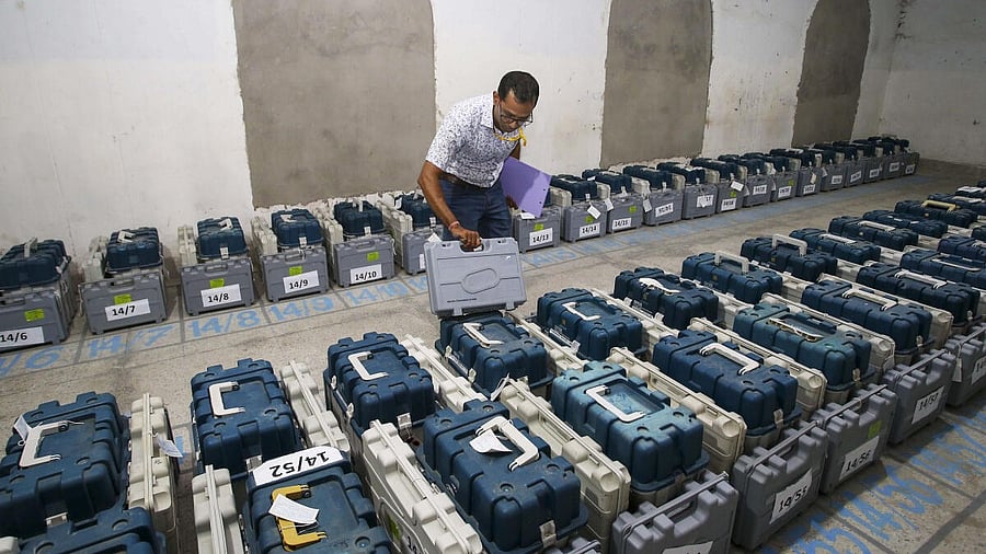 <div class="paragraphs"><p>A polling official checks Electronic Voting Machines (EVM) kept inside a strong room ahead of the first phase of voting for Lok Sabha elections, in Agartala. </p></div>