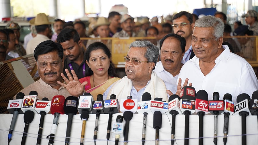 <div class="paragraphs"><p>Chief Minister Siddaramaiah speaks to media persons at Mysuru Airport, in Mysuru, on Monday. Ministers H C Mahadevappa and K Venkatesh, KPCC women’s wing president Pushpa Amarnath and MUDA Chairman K Marigowda are seen. </p></div>