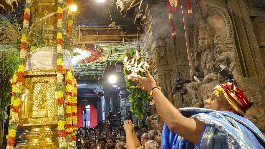 <div class="paragraphs"><p>A priest performs prayers for the flag hoisting at the Meenakshi Amman temple in connection with Chithirai festival.</p></div>