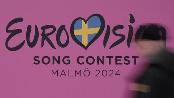 <div class="paragraphs"><p>A person walks past a sign for the 2024 Eurovision Song Contest in Malmo, Sweden, April 17, 2024</p></div>