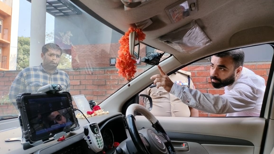 A dash camera being installed in a Hoysala patrol vehicle.