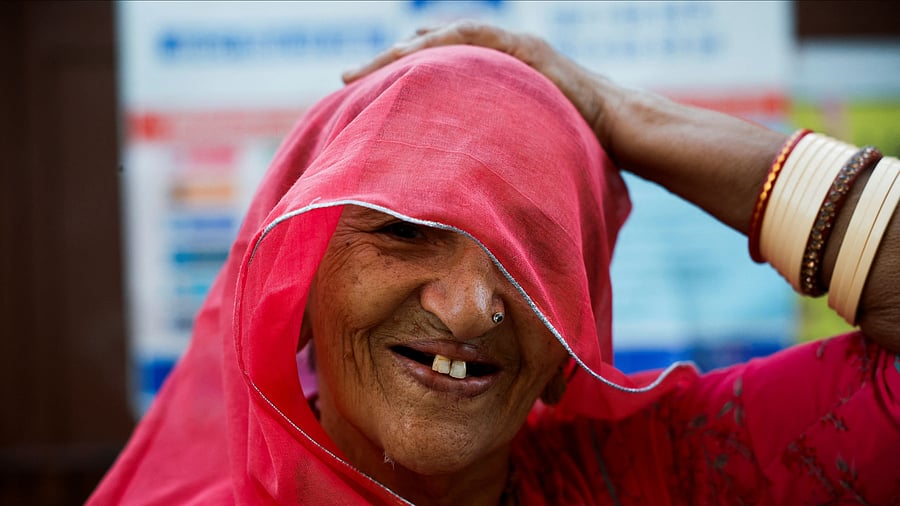 <div class="paragraphs"><p>A woman stands inside a polling station as she waits to cast her vote during the second phase of the general elections, in Barmer, Rajasthan, April 26, 2024. </p></div>