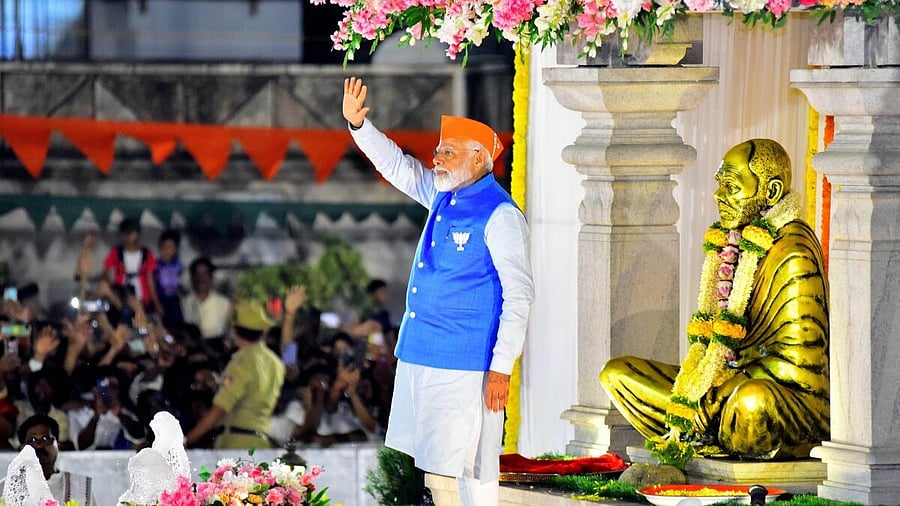 <div class="paragraphs"><p>Prime Minister Narendra Modi waves at supporters before a road show ahead of Lok Sabha polls, in Mangaluru. </p></div>