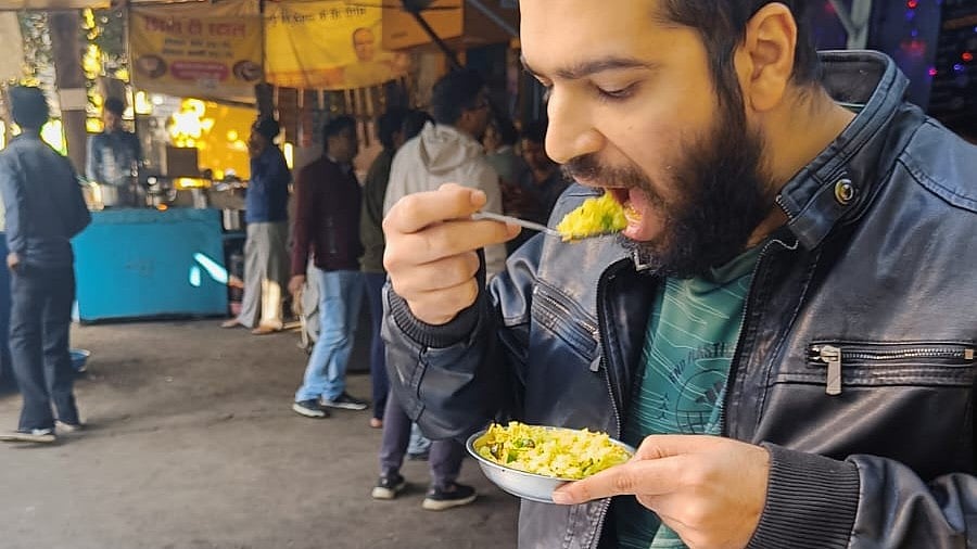 <div class="paragraphs"><p>File photo of a person eating poha in Indore. </p></div>