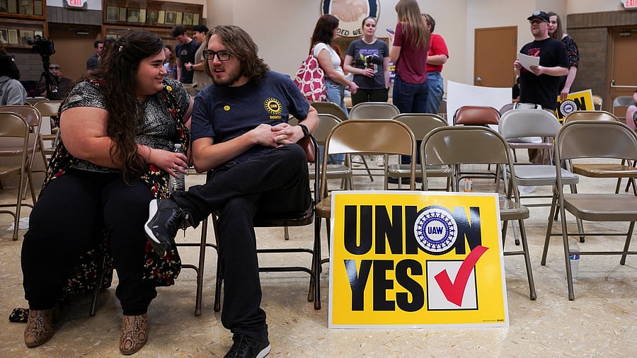 <div class="paragraphs"><p>People sit next to a placard that says 'Union Yes' as the result of a vote comes in favour of the hourly factory workers at Volkswagen's assembly plant to join the United Auto Workers union, during a watch party in Chattanooga, Tennessee.</p></div>