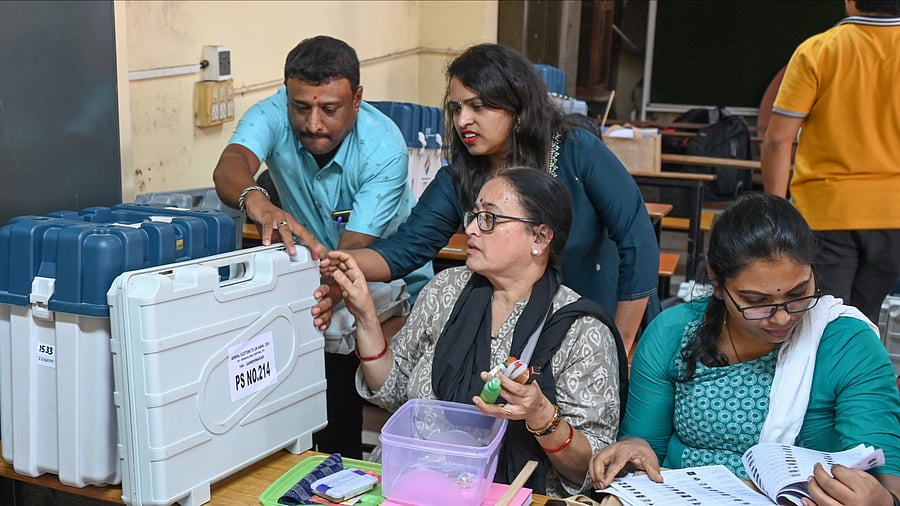 Polling officials inspect election materials at the mustering centre in Bengaluru on Thursday. DH PHOTO/S K Dinesh & B K Janardhan