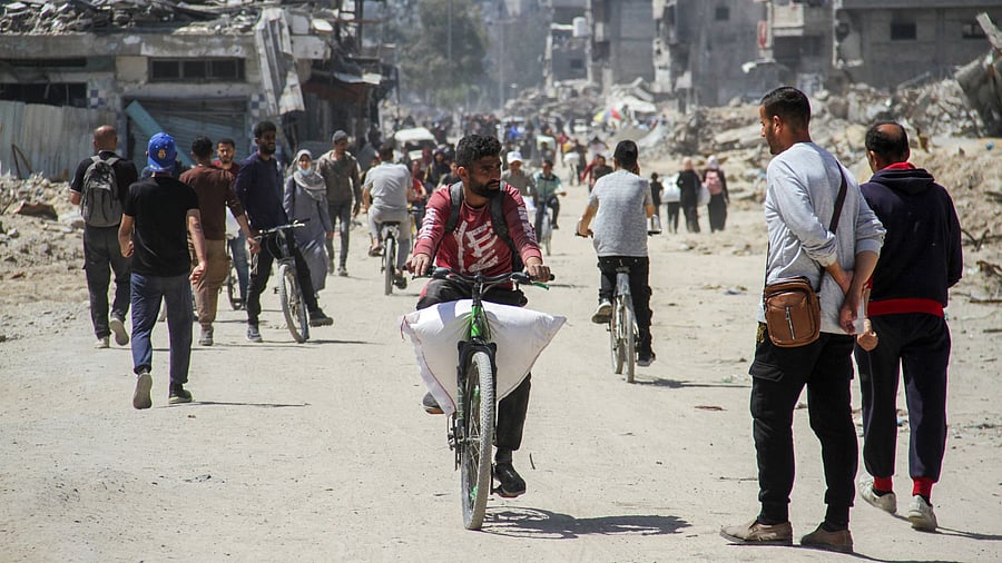 <div class="paragraphs"><p>A Palestinian man transports a bag of flour on his bicycle, amid a widespread hunger, as the conflict between Israel and the Palestinian Islamist group Hamas continues, in Gaza City.</p></div>