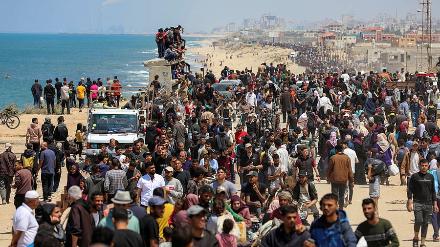 <div class="paragraphs"><p>Palestinians, who were displaced by Israel's military offensive on south Gaza, make their way as they attempt to return to their homes in north Gaza, amid the ongoing conflict between Israel and Hamas, as seen from central Gaza Strip.</p></div>