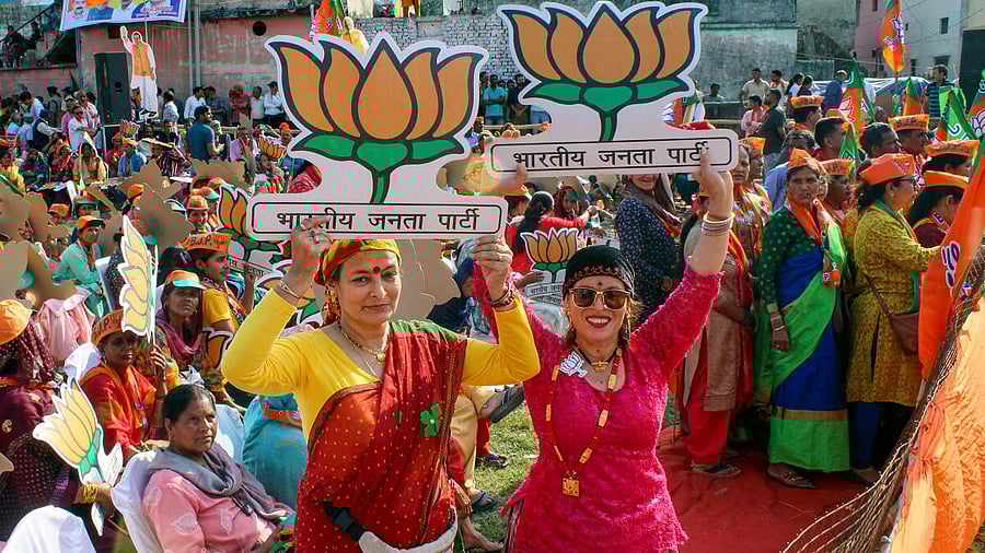 <div class="paragraphs"><p>BJP supporters pose for photos during BJP National President JP Nadda's rally ahead of the upcoming Lok Sabha election. </p></div>