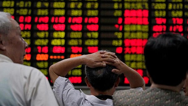 <div class="paragraphs"><p>Investors look at an electronic board showing stock information at a brokerage house in Shanghai, China.</p></div>