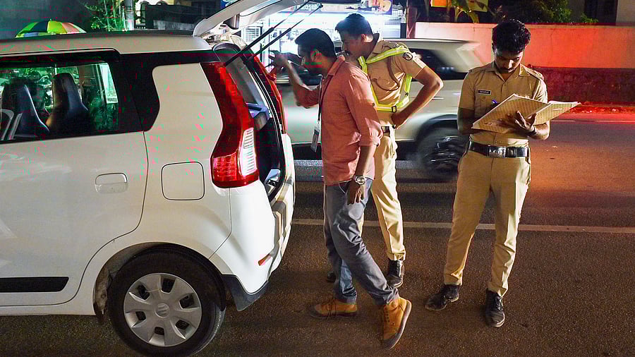 <div class="paragraphs"><p>Police personnel check a vehicle ahead of Lok Sabha elections.</p></div>