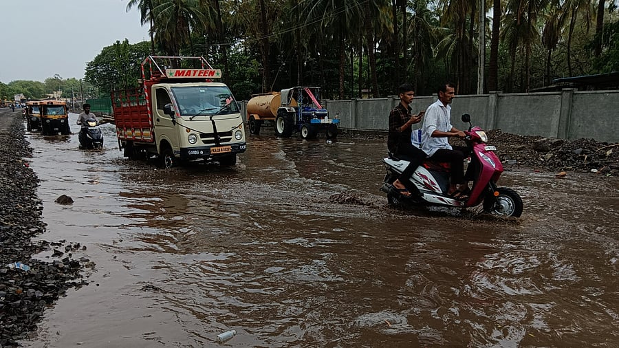 <div class="paragraphs"><p>Motorists navigate a waterlogged road following heavy rain in Vijayapura on Friday. <br><br><br></p></div>