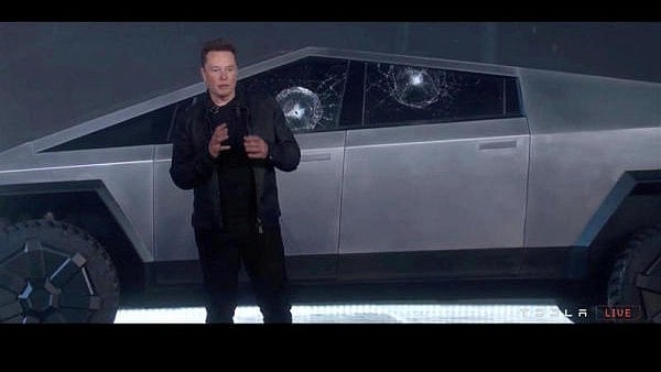 <div class="paragraphs"><p>Tesla Chief Executive Elon Musk stands in front of the cracked windows of company's first electric pickup truck, the Cybertruck, after it was unveiled and a metal ball was thrown at the windows, in Los Angeles.</p></div>
